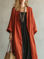 Terracotta Colored Bohemian Style Cardigan Paired With A Black Long Skirt